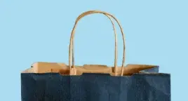 The top of a paper shopping bag, cutout on blue background